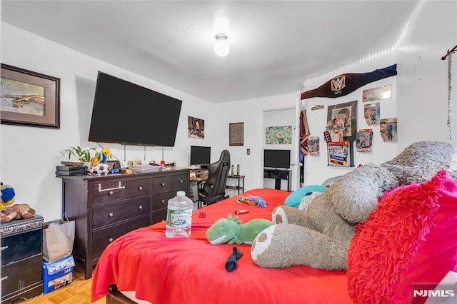 bedroom with light parquet floors