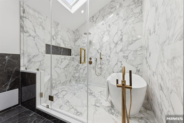 bathroom featuring tile walls, a skylight, and shower with separate bathtub