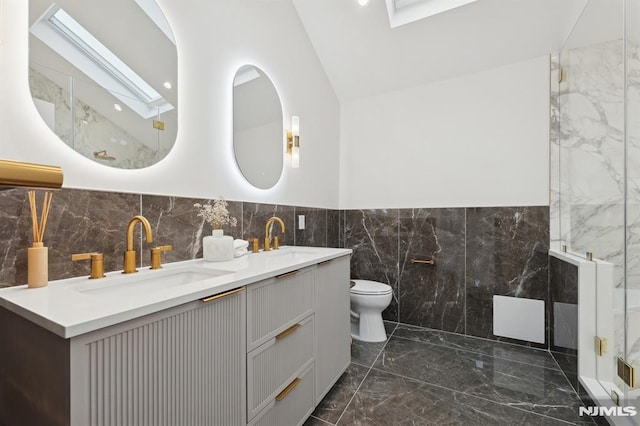 bathroom with toilet, lofted ceiling with skylight, walk in shower, and vanity