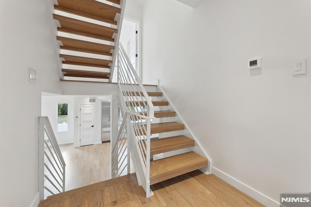 stairway with hardwood / wood-style floors