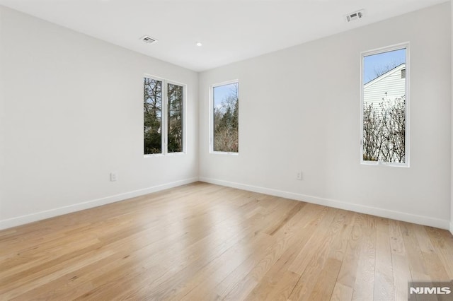 unfurnished room with light hardwood / wood-style floors