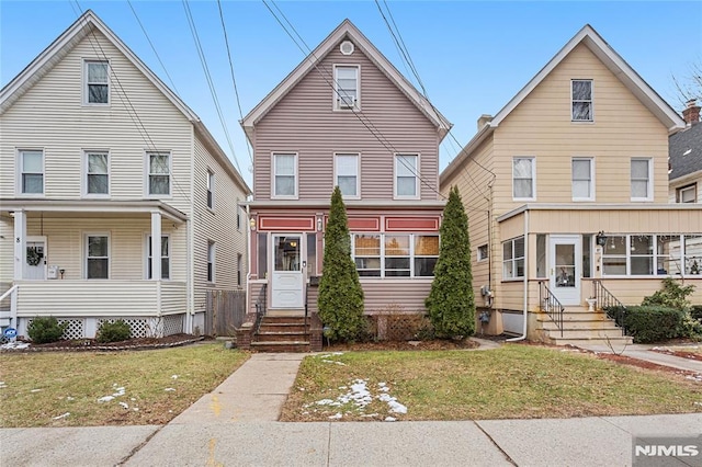 view of property featuring a front lawn