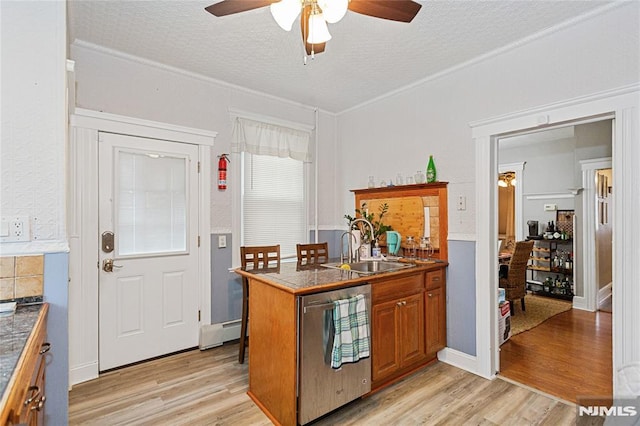 kitchen with baseboard heating, dishwasher, ceiling fan, sink, and light hardwood / wood-style flooring