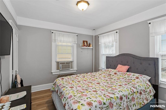 bedroom with dark wood-type flooring and cooling unit