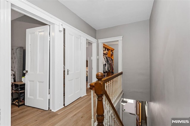 corridor with light hardwood / wood-style floors