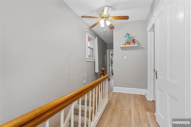 corridor with light hardwood / wood-style floors