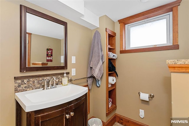 bathroom with vanity and tasteful backsplash