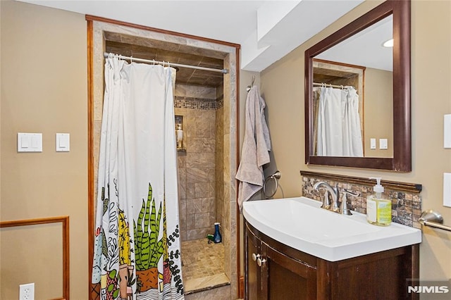 bathroom featuring vanity, tasteful backsplash, and curtained shower