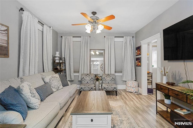 living room featuring light wood-type flooring and ceiling fan