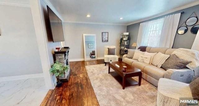 living room featuring hardwood / wood-style flooring and ornamental molding