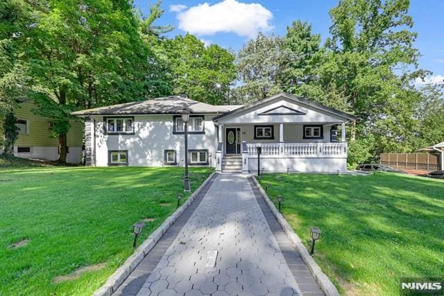 bungalow-style house with covered porch and a front yard