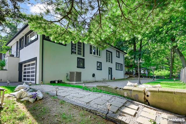 view of side of home featuring a garage and central air condition unit