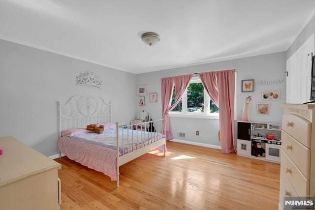 bedroom with light hardwood / wood-style floors