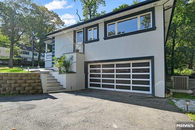 view of front facade with a garage and cooling unit