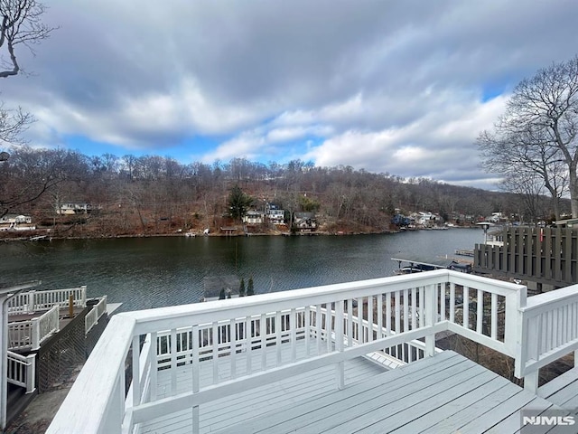 view of dock with a deck with water view