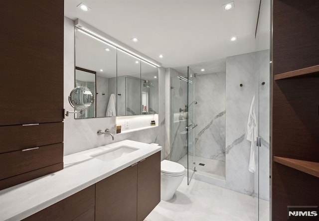 bathroom featuring vanity, an enclosed shower, and toilet