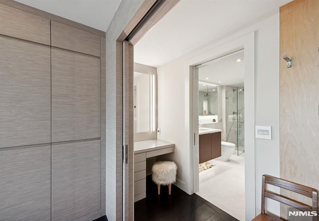 bathroom with vanity, an enclosed shower, and toilet