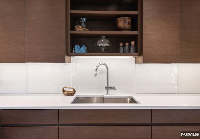 kitchen featuring dark brown cabinetry and sink