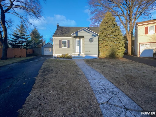 bungalow-style house with an outbuilding and a garage