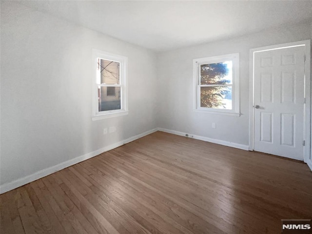 unfurnished room featuring hardwood / wood-style floors