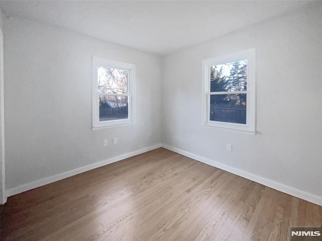 unfurnished room featuring hardwood / wood-style floors