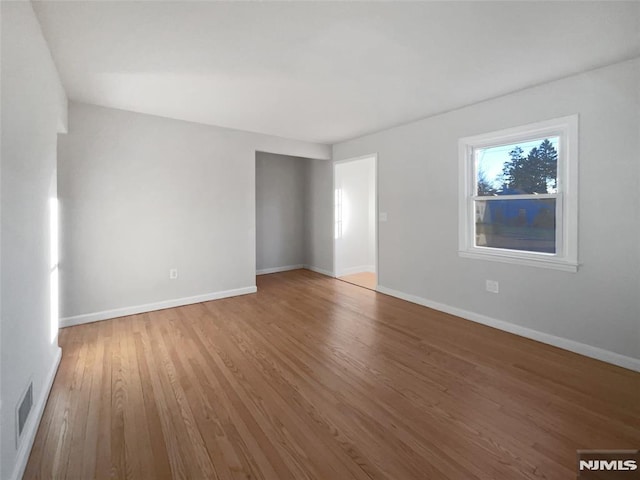 spare room with hardwood / wood-style floors