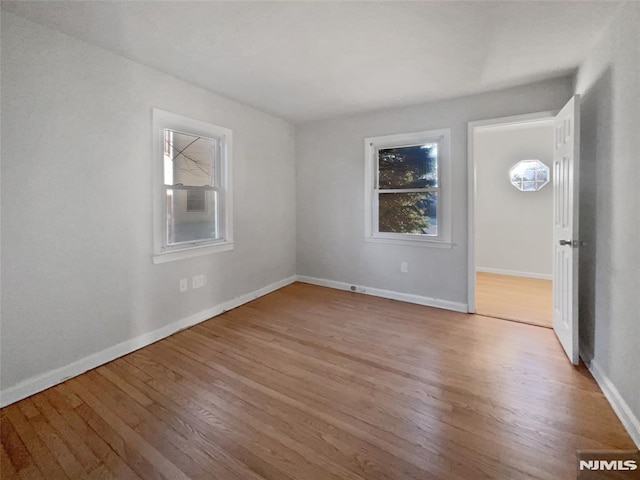 empty room with hardwood / wood-style floors