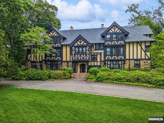 tudor house featuring a front yard