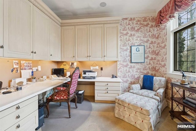 carpeted office space with built in desk and crown molding