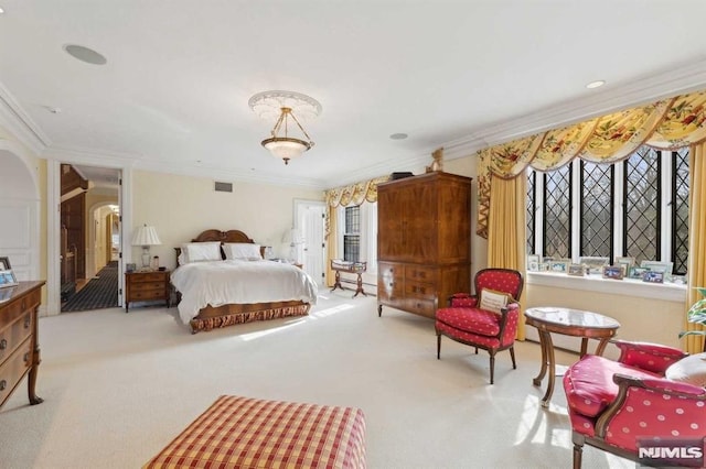 carpeted bedroom featuring crown molding