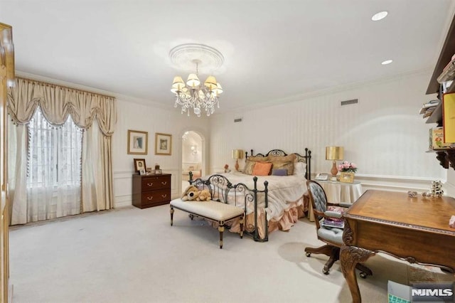 carpeted bedroom featuring crown molding and an inviting chandelier