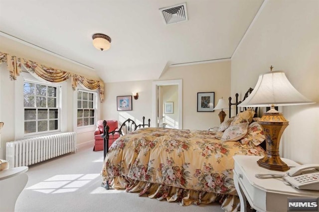 carpeted bedroom featuring lofted ceiling, radiator heating unit, and ornamental molding