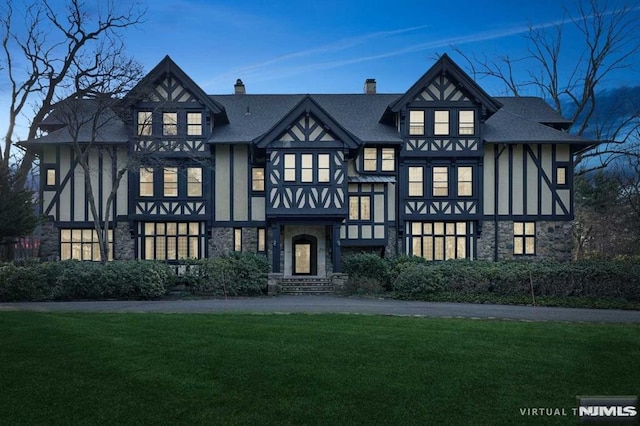 tudor house featuring a front lawn