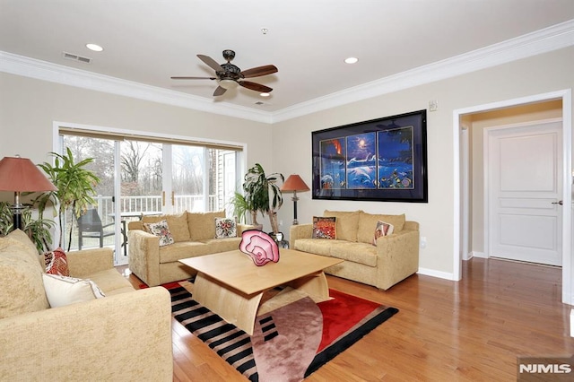 living room with crown molding and hardwood / wood-style floors