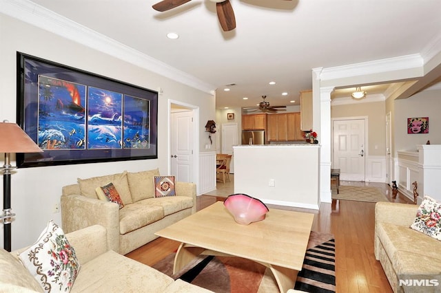 living room with light hardwood / wood-style flooring and crown molding