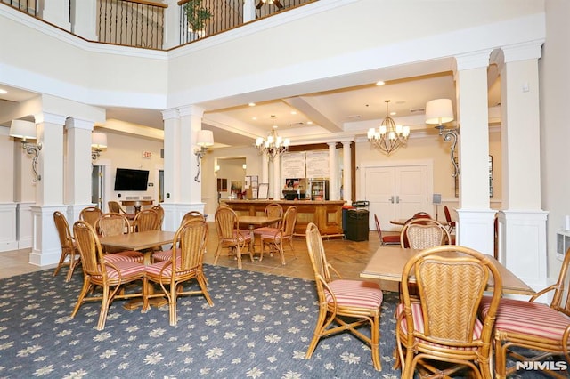 dining space with a high ceiling and an inviting chandelier