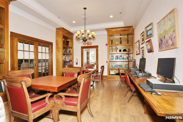 dining space featuring a chandelier, light hardwood / wood-style floors, ornamental molding, and french doors