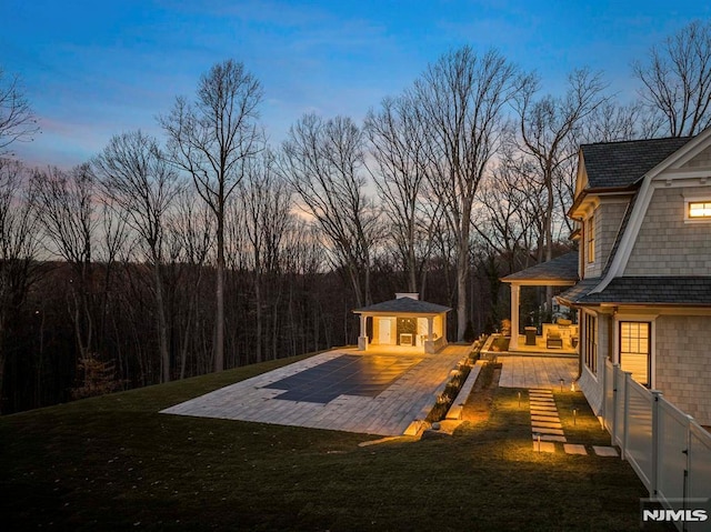 yard at dusk with a patio