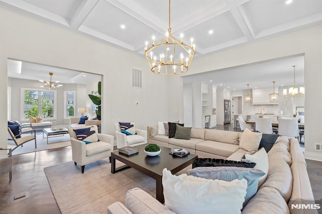 living room featuring beamed ceiling, parquet floors, a chandelier, and coffered ceiling