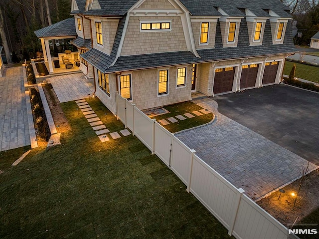 view of front of home with a garage and a front lawn