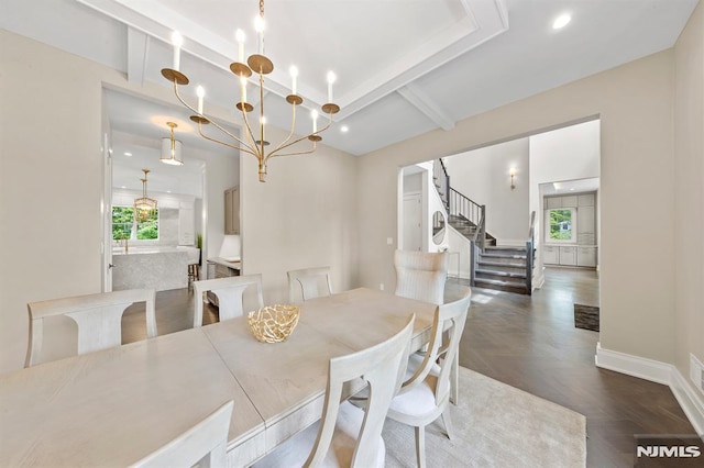 dining room with beamed ceiling, dark parquet flooring, and a chandelier