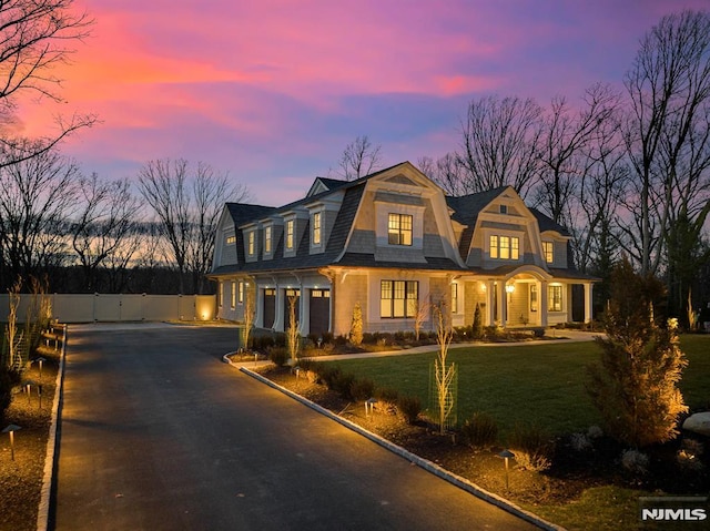 view of front of house with a lawn and a garage