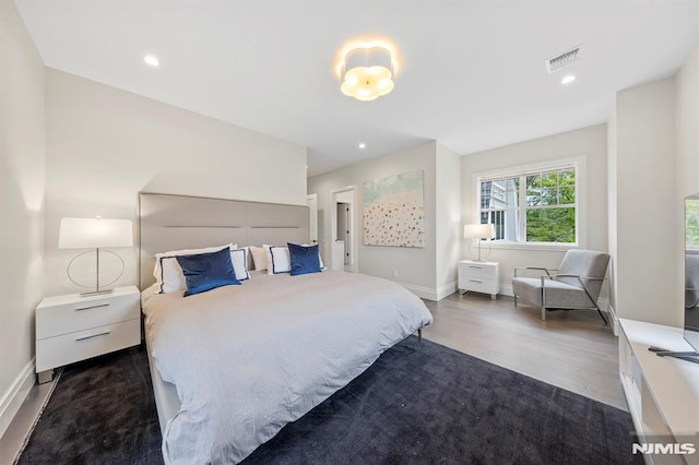 bedroom with dark wood-type flooring