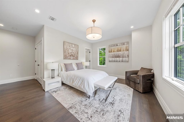 bedroom with dark hardwood / wood-style flooring