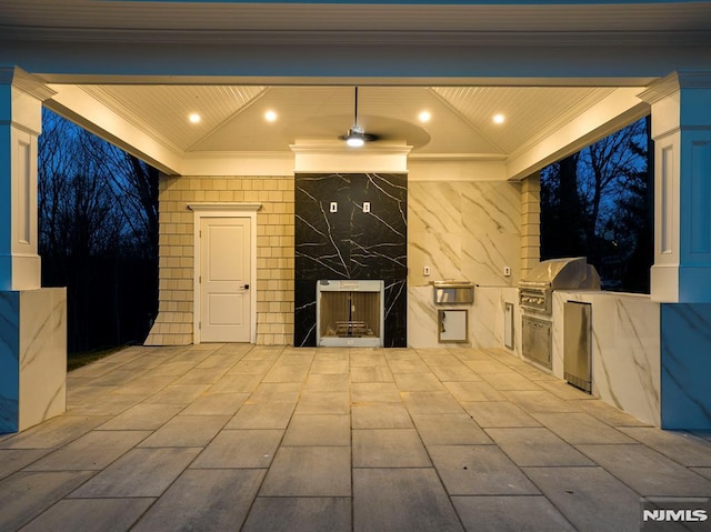 view of patio / terrace with an outdoor kitchen and a grill