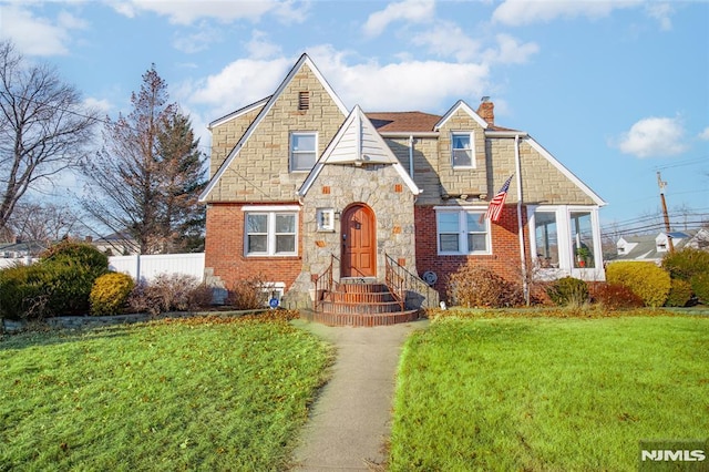 tudor home featuring a front yard