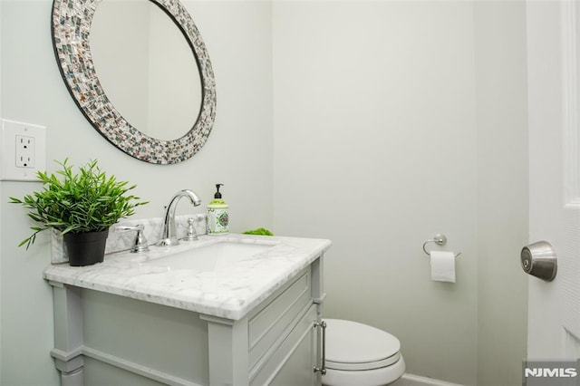 bathroom featuring toilet and vanity