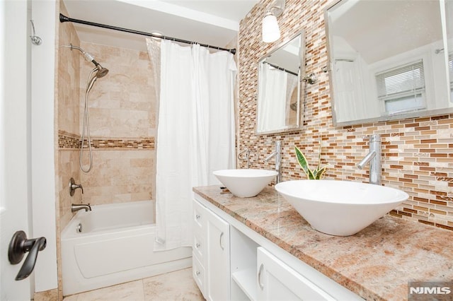 bathroom with tasteful backsplash, tile patterned flooring, shower / bath combo, and vanity