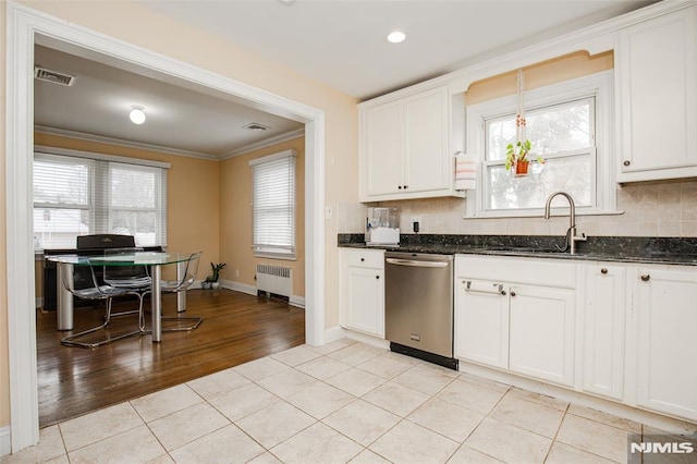 kitchen featuring radiator, white cabinetry, dishwasher, and light tile patterned floors