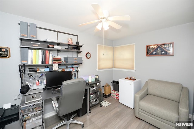 office with light hardwood / wood-style floors and ceiling fan